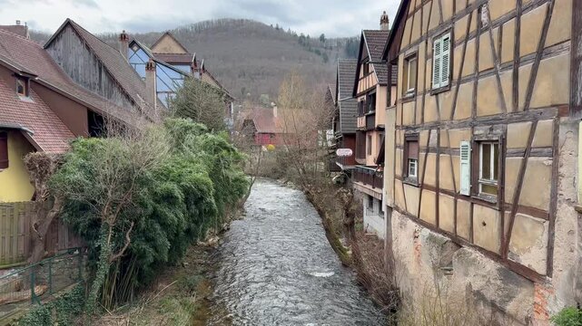 Traditional timberframe houses at Kaysersberg town centre. Motion of Weiss river water. Panoramic, scenic view. Kaysersberg, Alsace, France