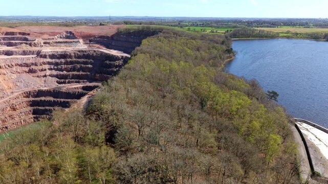 Aerial view of ancient Buddon Wood between Swithland Reservoir and Mountsorrel Quarry in Leicestershire UK