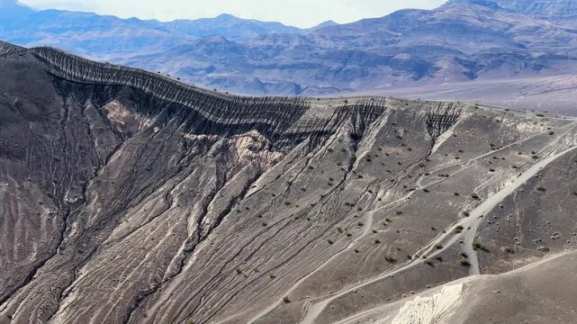 Handheld telephoto shot panning shot from the base of Ubehebe Crater in Death Valley, California. 4K