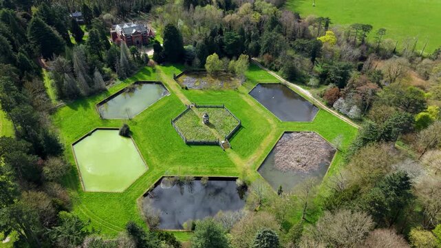Top down aerial view of hexagonal water filter beds and central valve house, showcasing Victorian industrial symmetry in England.