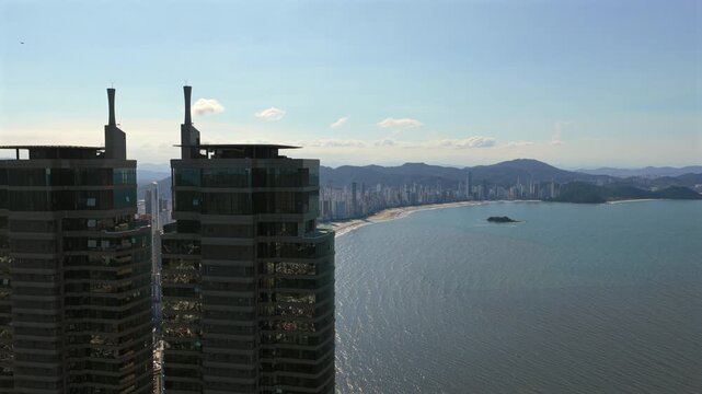 Yachthouse Residence Club twin towers at Avenida Normando Tedesco 1333 in Barra Sul, Balne&aacute;rio Cambori&uacute;, Santa Catarina, Brazil, overlooking Atlantic Ocean and Praia Central with dense skyline, orbit