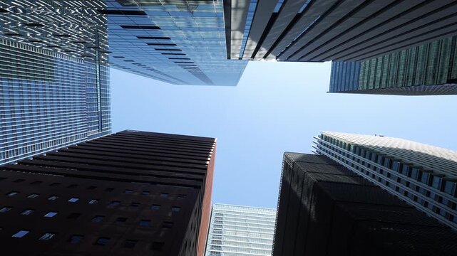 Corporate towers and glass skyscrapers against a clear Tokyo sky.
