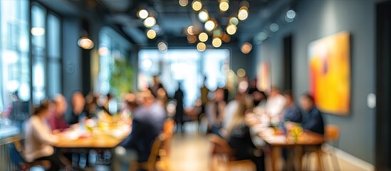 Fototapeta premium Blurred shot of a vibrant gathering, people at tables in a stylish indoor space