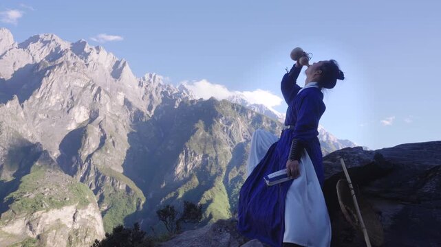 Epic Wuxia Swordsman Drinks Wine on Snow-Capped Mountain Peak, Ancient Chinese Wanderer Hiking Through Himalayan Valley at Sunrise