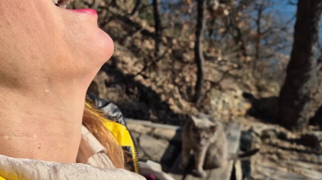 Woman drinking water close up shot of a female hiking and hydrating on a sunny day outdoors