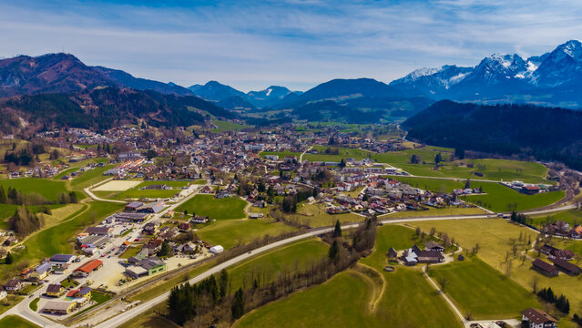 Aerial view of the valley town nestled amid rolling green hills and majestic mountains, a serene blend of nature and architecture, Windischgarsten, Upper Austria, Austria.