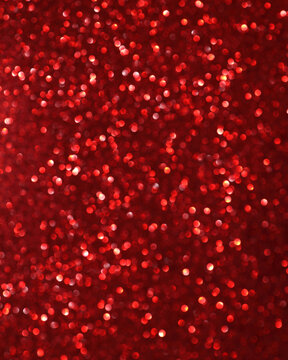 Vibrant red glitter bokeh abstract background. Sparkling shimmering texture for celebration, holiday, Christmas, New Year design