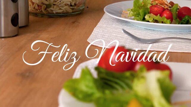 Animation of feliz navidad christmas greetings text over christmas dinner