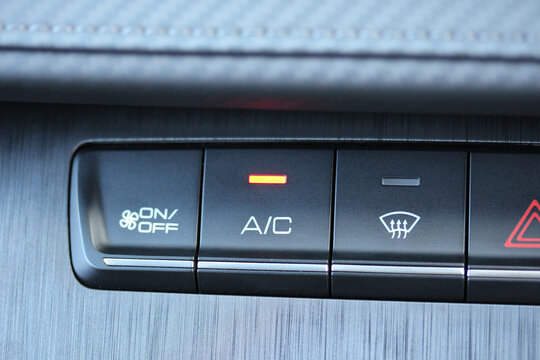 Illuminated A/C button on a new vehicle dashboard