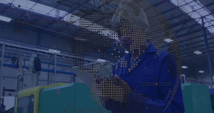 technician reading tablet and scrolling by factory machine while map overlay providing data feed