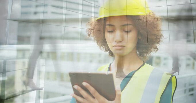 Site inspector wearing helmet, vest tapping tablet causing glass overlays while doing safety check