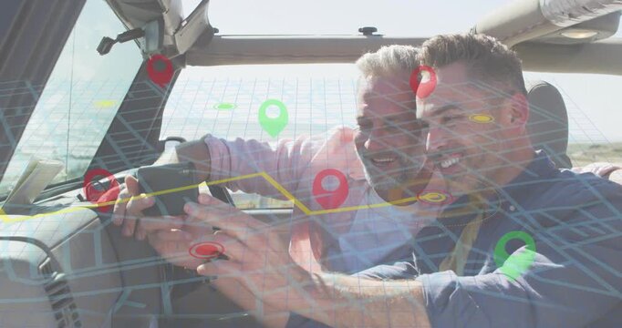 Two men leaning on mounted smartphone, tapping and plotting navigation route, revealing map overlay