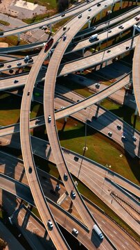 Freeways crossing in Dallas, Texas, USA. Top view on the cars going by the roads at daytime.
