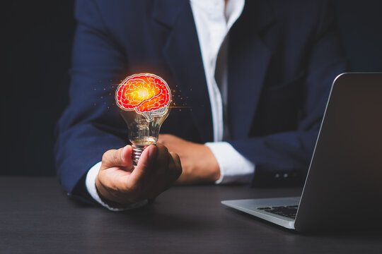 Business person holding glowing brain idea concept