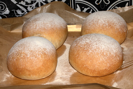 Home made bread roll baps freshly cooked with flour sprinkled on top