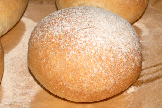 Home made bread roll baps freshly cooked with flour sprinkled on top