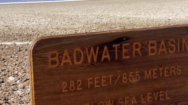 Handheld close-up panning shot of the Below Sea Level sign at Badwater Basin in Death Valley, California. 4K