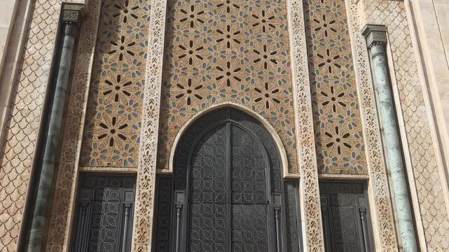 Hassan II Mosque ornate door and tilework close-up,"Hassan II Mosque ornate bronze door zellige tilework detail Casablanca Morocco