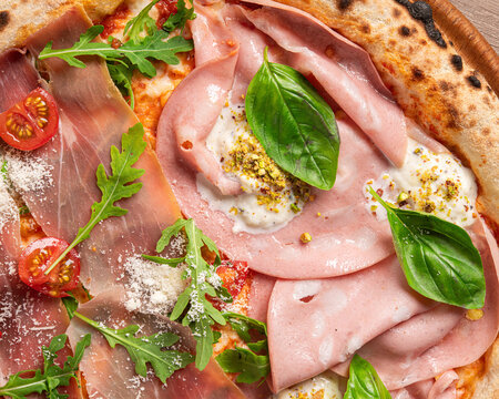 Fresh gourmet pizza topped with mortadella