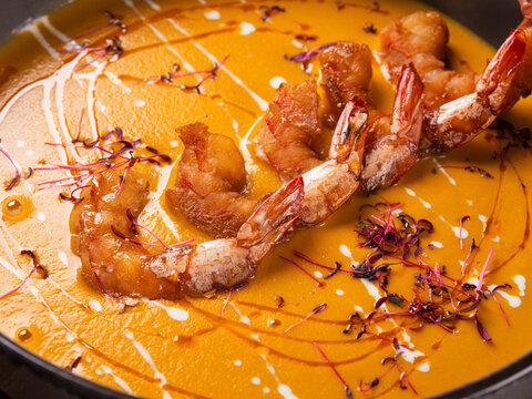 Creamy pumpkin soup topped with grilled shrimps