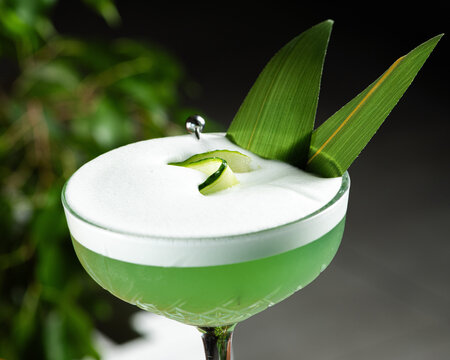 Refreshing green cocktail with thick white foam