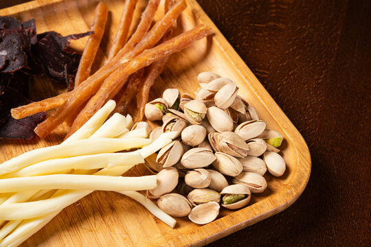 Assorted beer snacks including pistachios