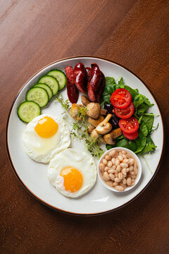 Hearty english breakfast with fried eggs, sausages