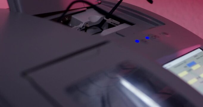 Close up of eyeglasses placed inside an optical tracer machine for frame measurement in a laboratory