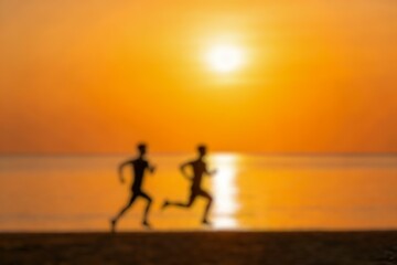 Fototapeta premium Silhouettes of two runners sprinting along a beach at sunset, capturing energy, motion, and a healthy active lifestyle against a glowing horizon.