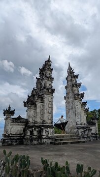 Woman Practicing Yoga at Balinese Candi Bentar Gate, Spiritual Meditation and Wellness Concept at Ancient Hindu Temple Overlooking the Sea