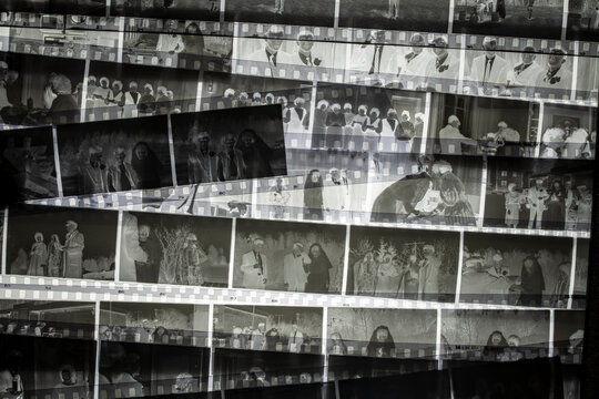 Collection of vintage black and white film negatives arranged in layers creating an abstract collage background concept for photography history memory archive and retro media design. Top view