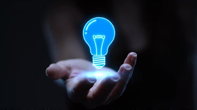 Illuminating bulb symbol of innovation and creative ideas hovering above a person's hand in a dark, futuristic setting
