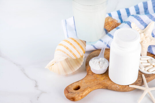 Sea or Marine collagen, in powder, pills and drink with medical bottle jar mock-up and with seashells and starfish copy space