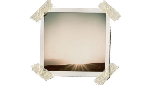 Retro instant photo of a sunset over a field, taped on transparent background