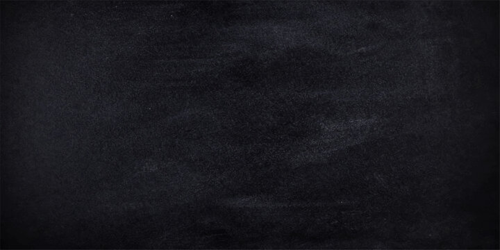 Black chalkboard texture background with rough grunge surface and chalk marks suitable for backdrop