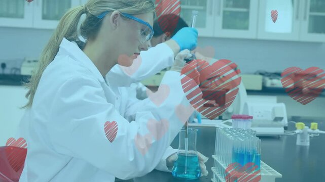 Animation of heart icons over diverse scientists with pipette