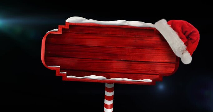 Animation of santa hat over covered red signboard with copy space against black background