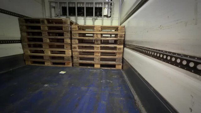 Refrigerated truck empty pallet stacks panning