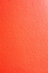Fototapeta premium Abstract red wall texture with rough plaster surface for background and design use
