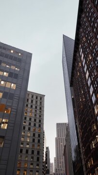 evening light urban avenue with glowing office windows, busy sidewalks, traffic streaks and layered highrises conveying afterwork energy and metropolitan rhythm