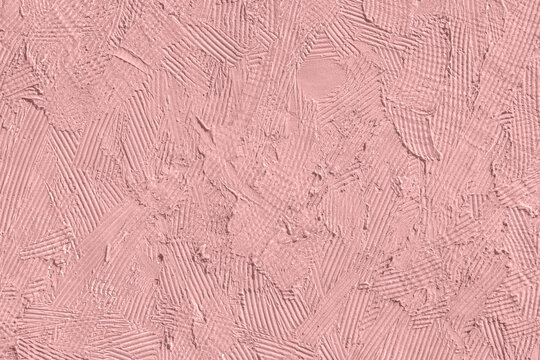 Abstract dusty rose plaster texture with rough patterned strokes, creating a soft tactile surface background.