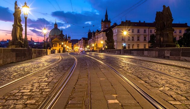 Historic Charles Bridge at Dusk with Tram Tracks and City Lights.