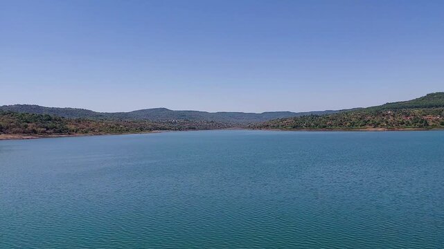 4K Tulsi Lake Mumbai water reservoir, serene freshwater lake inside Sanjay Gandhi National Park surrounded by dense forest and green hills Maharashtra

