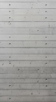 A minimalist, full-frame texture of a grey architectural concrete wall featuring horizontal formwork lines and symmetrical tie-rod holes