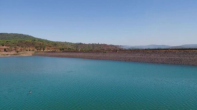 4K Vihar Lake Mumbai historic water reservoir, calm freshwater lake inside Sanjay Gandhi National Park with lush green hills and reflections Maharashtra India

