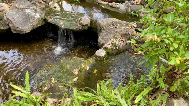 Waterfall over rocks in a garden