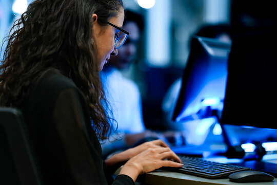 Senior software engineer debugging backend architecture code during agile sprint. Female developer reviewing syntax optimization strategy on digital screen.