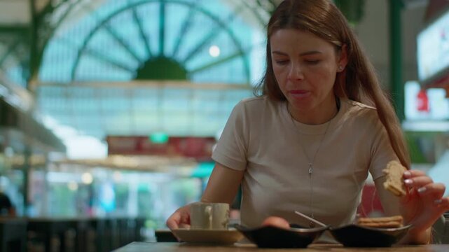 Woman tourist tasting local breakfast at Lau Pa Sat food market in Singapore with authentic street cuisine and travel experience in Asia
