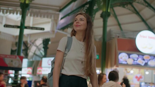 Female traveler visiting Lau Pa Sat food court in Singapore and observing delicious street food stalls, travel and tourism in Asia