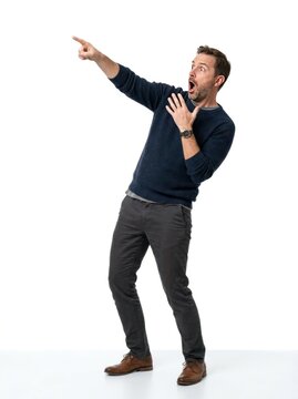 Man pointing and reacting with exaggerated shock or surprise.